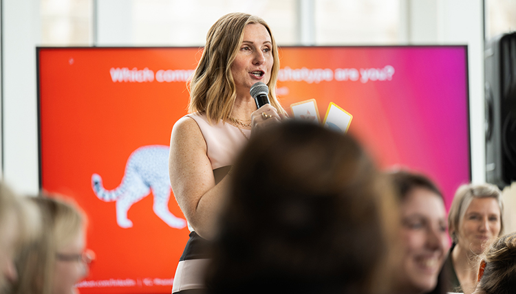 A Woman stands holding a microphone