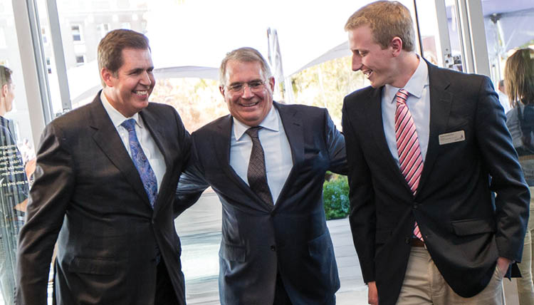 President McCulloh walks arm-in-arm with donor John Hemmingson and GSBA President Taylor Kratochvil ('16).