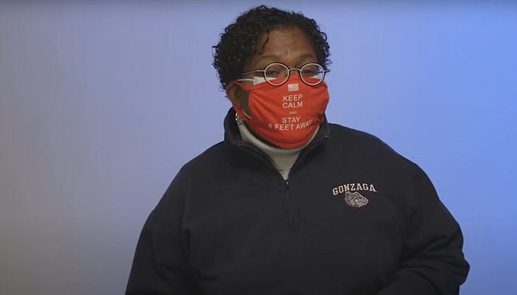 woman wearing GU sweatshirt and a red mask that says Keep Calm and Stay 6 Feet Away