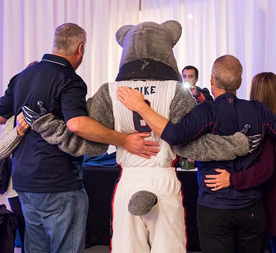 Spike the Bulldog taking a photo with people