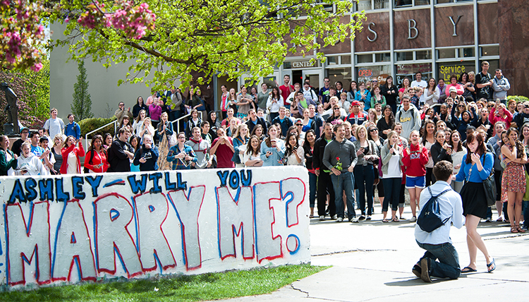 student proposes to girlfriend by the wall