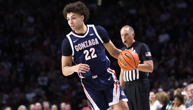 Men's basketball player Anton Watson dribbling a ball. 