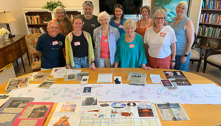 The Bonner County Human Rights Task Force members stand behind a table of research materials