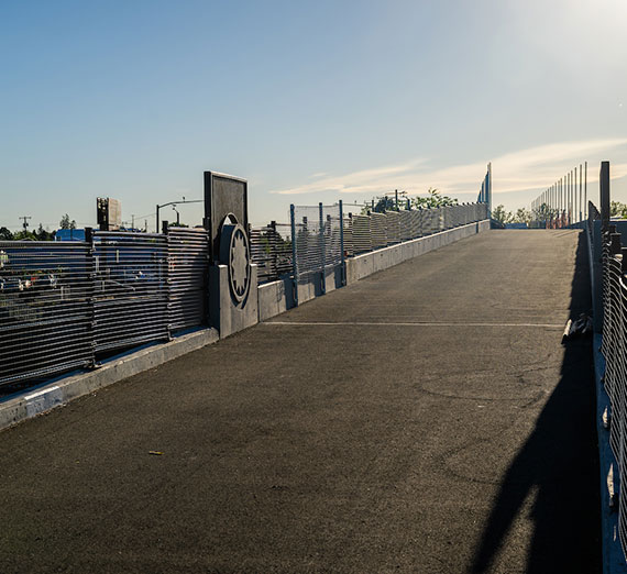 A paved trail with sun signs along the side