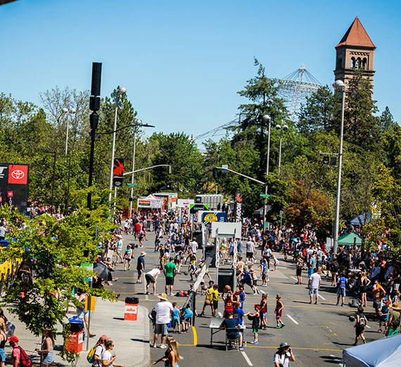 A Spokane street with people playing basketball on them