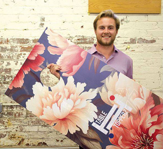 Gonzaga student Jack holding a cornhole board. 