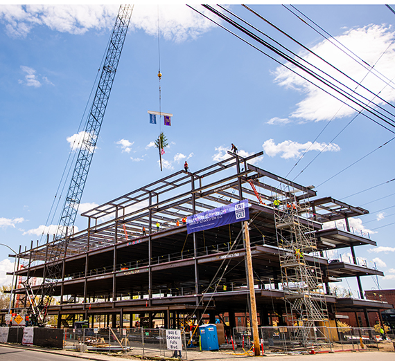 The final beam is lowered onto the now-completed University of Washington School of Medicine/Gonzaga University Health Partnership building. 
