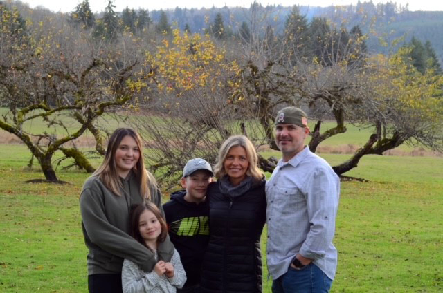 husband and wife with three kids