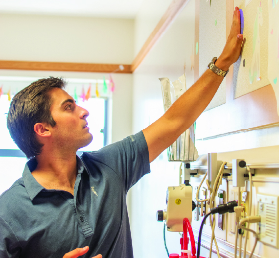 Thomas Gonzalez decorating a hospital room