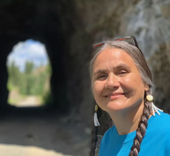 Native American woman near train tunnel
