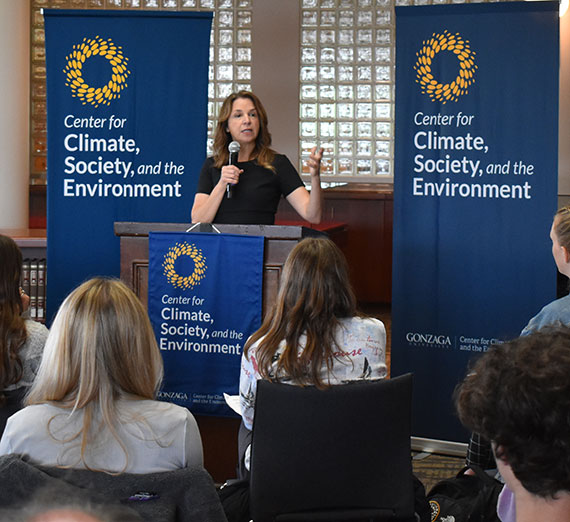 Washington State Lands Commissioner Hilary Franz at a podium speaking to students