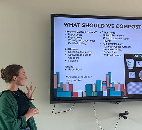 Tristy Osborn looks at a screen that lists things students can compost on campus