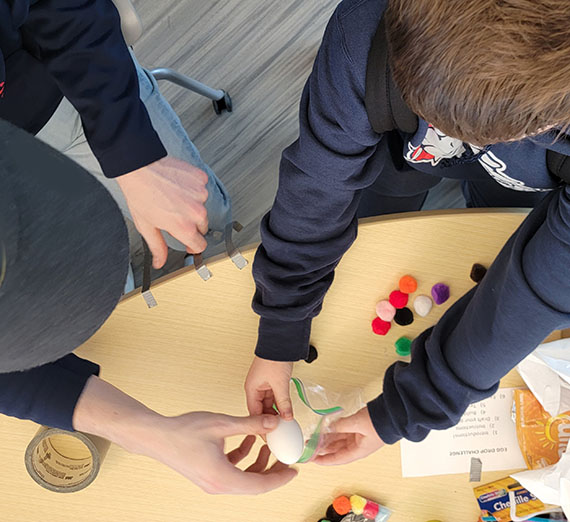 Gonzaga student and child with an egg