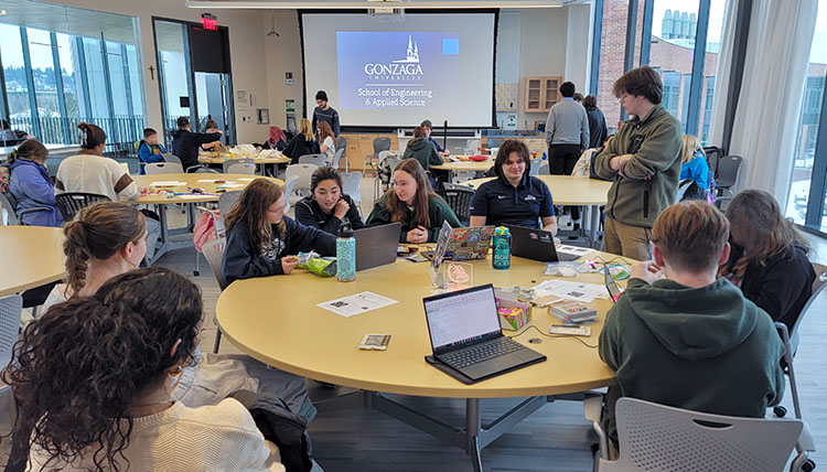 Room full of Gonzaga students and elementary school children with engineering projects