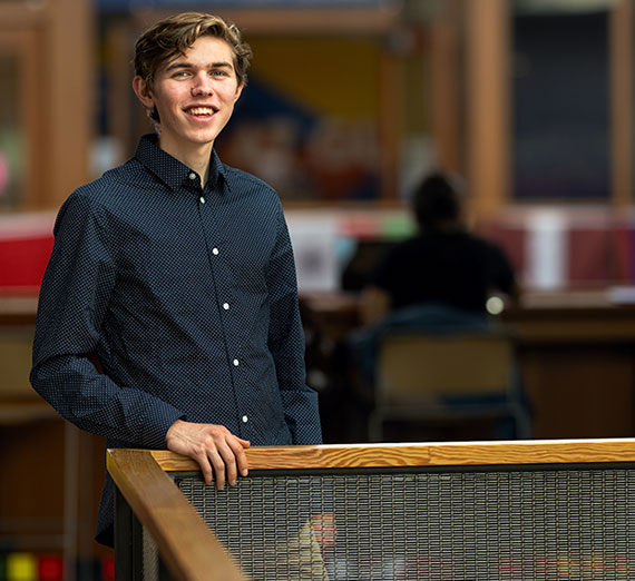 Reid Quiggins stands along a rail in Hemmingson Center
