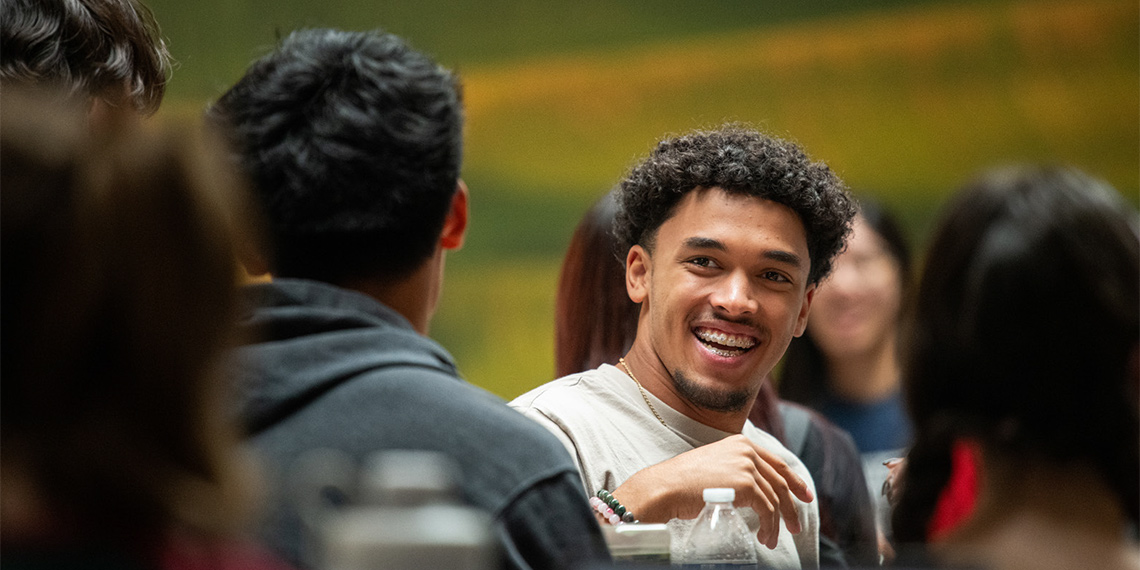 Students chat at a meal in the COG