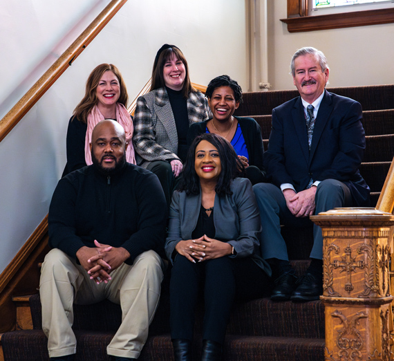 Office of Inclusive Excellence Staff on stairs,