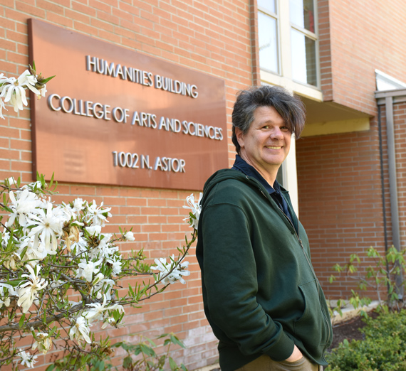 Brett Hendricks standing outside the humanities building.
