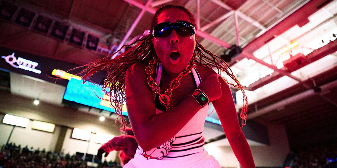 A woman in sunglasses cheers