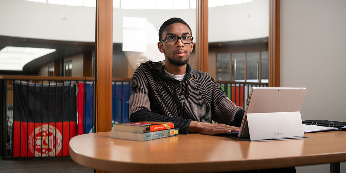 Gonzaga Senior Maalik Brown, Computer Science major, sitting at a table.