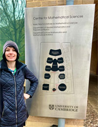 Melody Alsaker stands in front of the Isaac Newton Institute.