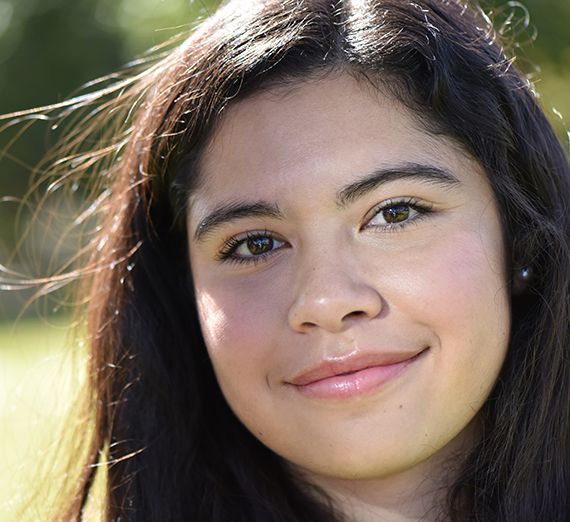 A woman with long dark hair smiling