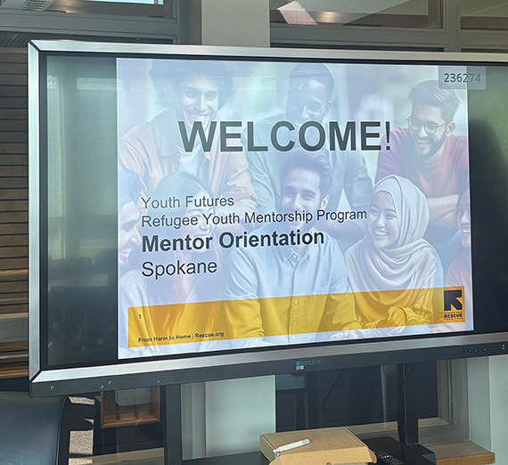 A TV screen with the words Welcome Mentor Orientation