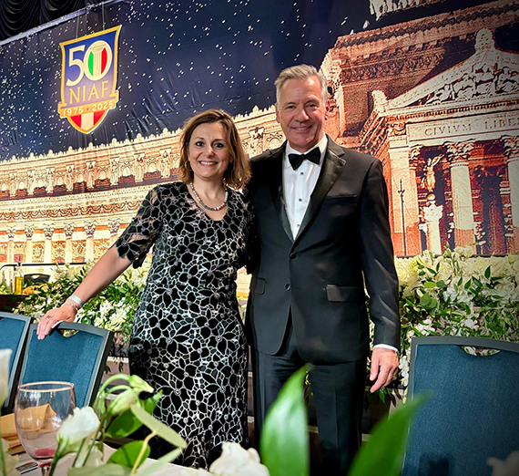 A woman in a dress and a man in a tuxedo on a stage