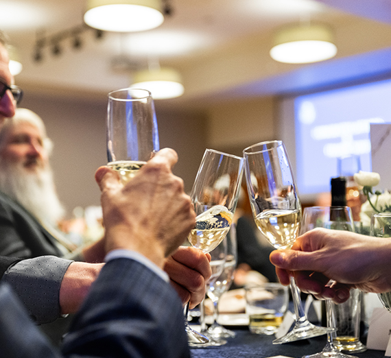 People cheers glasses.