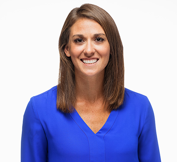 Ashley Blake, MASAA Alumna, wearing a blue shirt with white background