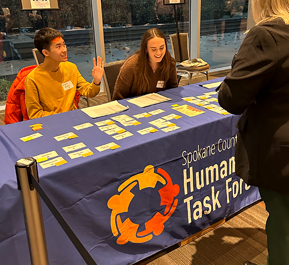 two students assisting at event