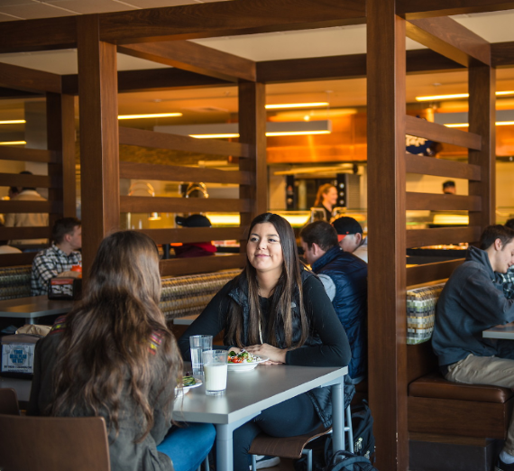 Two girls sitting in the COG chatting.