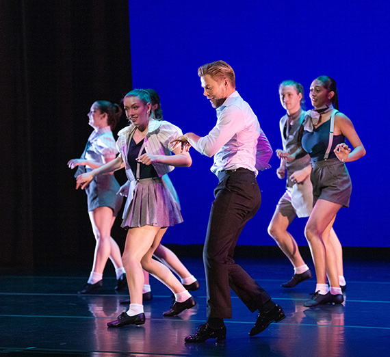 Derek Hough dancing alongside Gonzaga students during a campus speaking event.