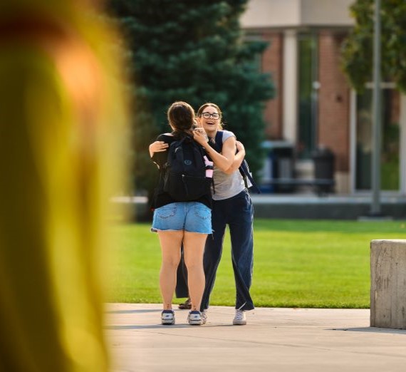 Students hugging along Bulldog Alley.
