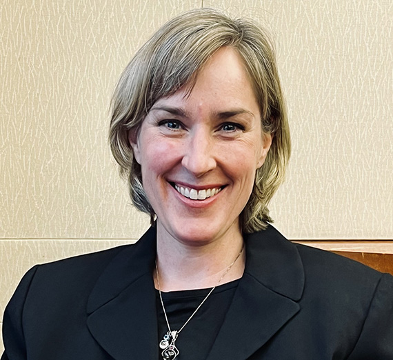 Headshot of Master's in Theology and Leadership alumna, Maureen Cleverley wearing a black top 
