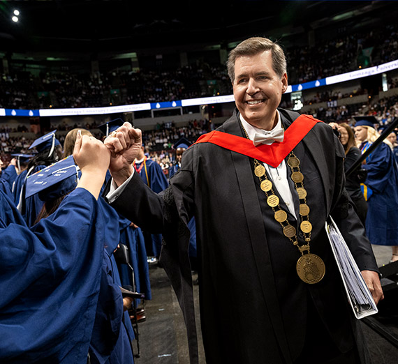Former President Thayne McCulloh congratulates a student at Gonzaga's Undergraduate Commencement ceremony