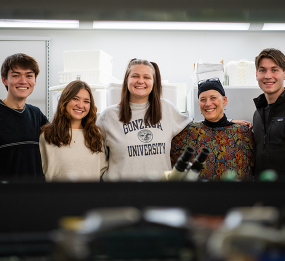 Nancy Staub poses and smiles with her research students.