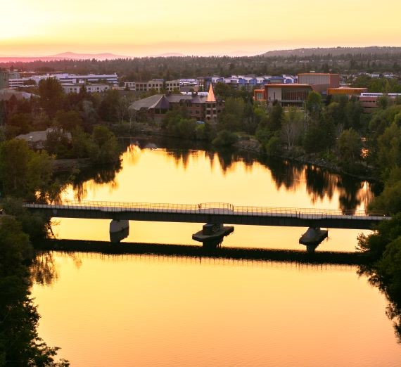 Sunset on the Spokane River overview shot of a bridge and the horizon leading to Downtown Spokane.