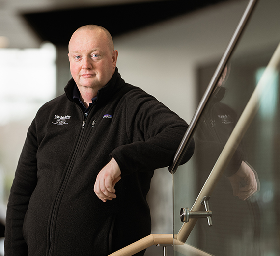 man on stairs with reflection in glass