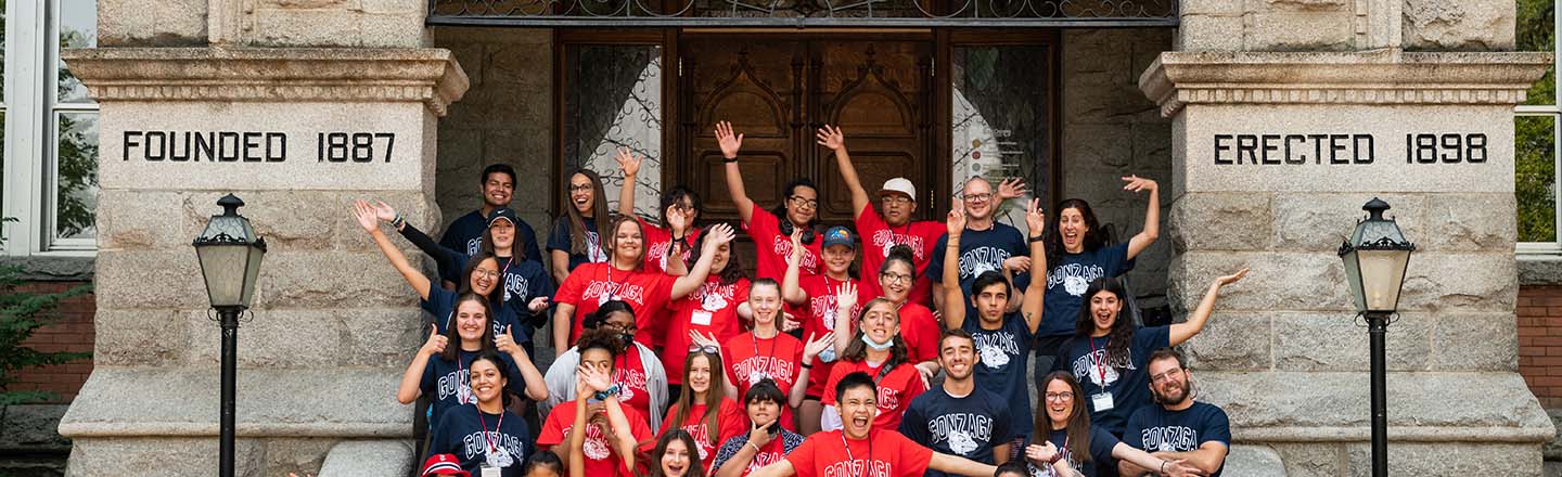 A large group of people gathered on the steps of college hall.
