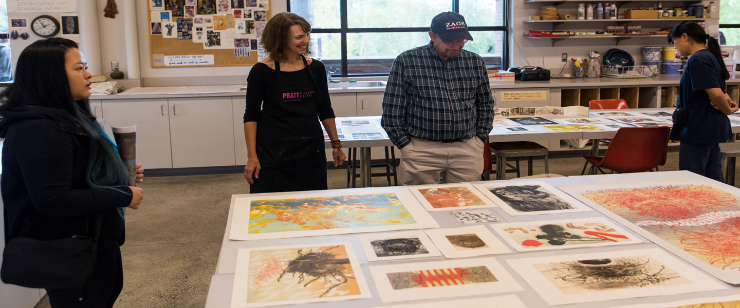 Visitors look at student art pieces 