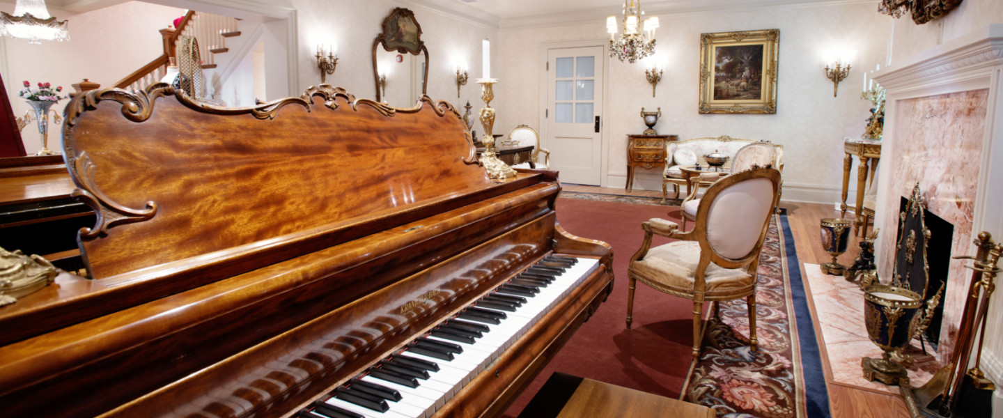 The Miss Myrtle Woldson Collection in the Myrtle Woldson Performing Arts Center, featuring her piano and a model of her former sitting room. 